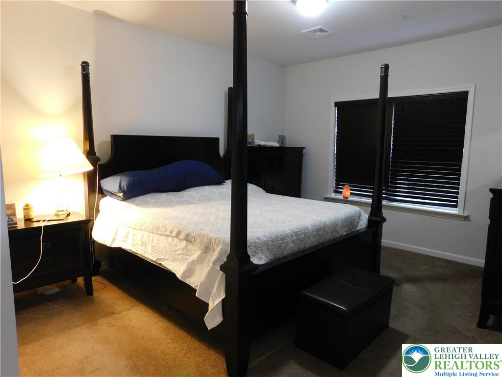 1047 Cetronia Road, Unit 3 Breinigsville, PA 18031 - Photo 10 of 19 a bed sitting in a bedroom next to a window