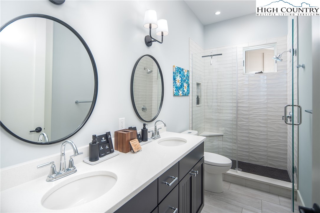 227 Calico Court Boone, NC 28607 - Photo 15 of 47 a bathroom with a toilet a sink and a mirror