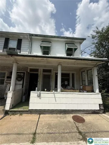 a view of a white house with large windows
