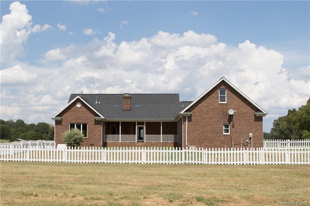 3112 Edwards Road Wingate, NC 28174 - Photo 4 of 21 a front view of a house with a garden and yard