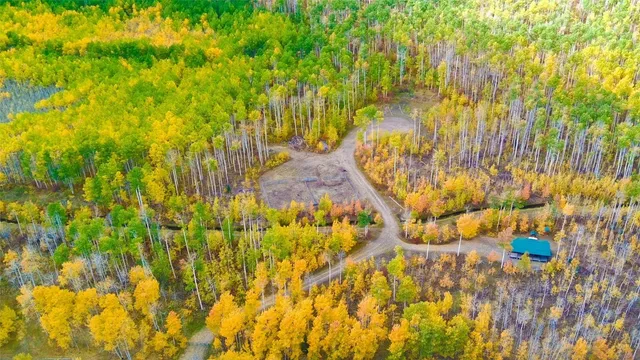 a view of a yard with wooden fence