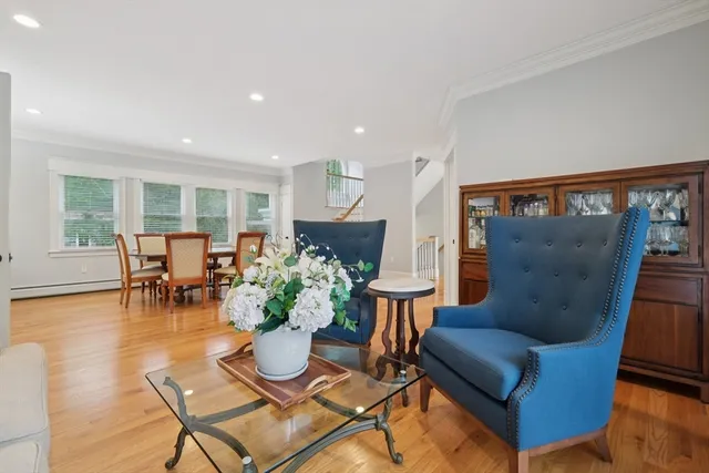 a living room with furniture and floor to ceiling windows