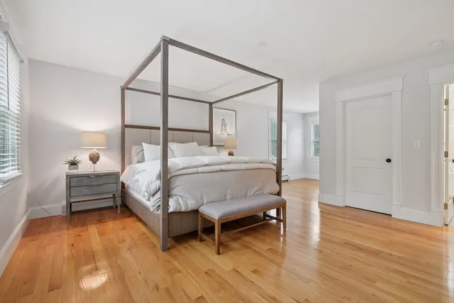 a living room with furniture and large windows