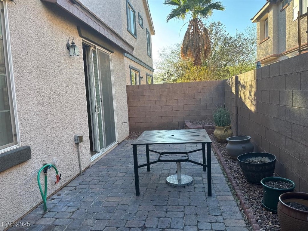 8690 West Diamond Sand Avenue Las Vegas, NV 89178 - Photo 22 of 25 Fenced backyard featuring a patio and outdoor dining space