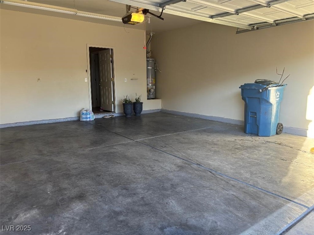8690 West Diamond Sand Avenue Las Vegas, NV 89178 - Photo 23 of 25 Garage with secured water heater and a garage door opener