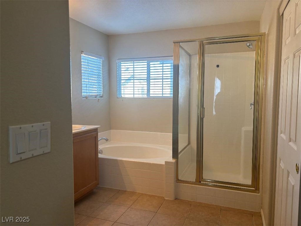 8690 West Diamond Sand Avenue Las Vegas, NV 89178 - Photo 9 of 25 Full bathroom featuring vanity, a bath, a shower stall, and light tile patterned floors