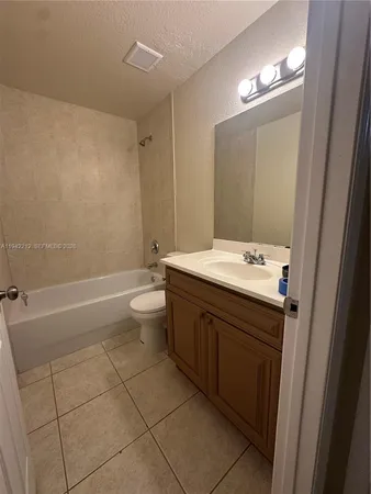 a bathroom with a double vanity sink toilet and shower