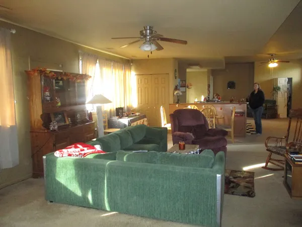 a living room with furniture and a chandelier