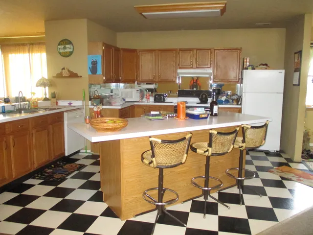a kitchen with a sink a stove a microwave and cabinets