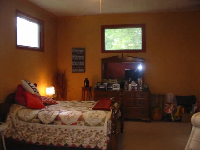 a bedroom with a bed and a window