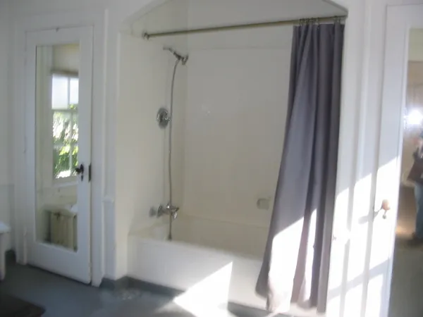 a bathroom with a tub and shower
