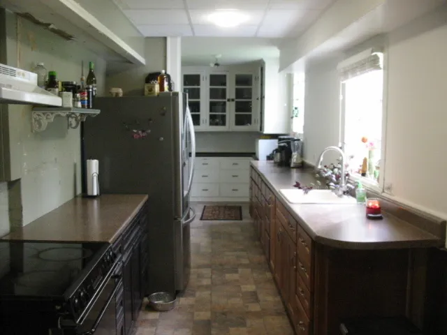 a kitchen with sink stove and cabinets
