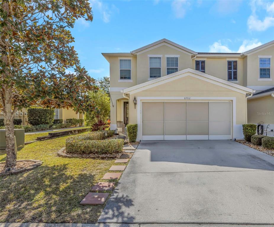 8702 Corinthian Way New Port Richey, FL 34654 - Photo 1 of 1 a front view of a house with a yard and garage