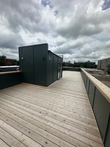 a black and white building with wooden floor