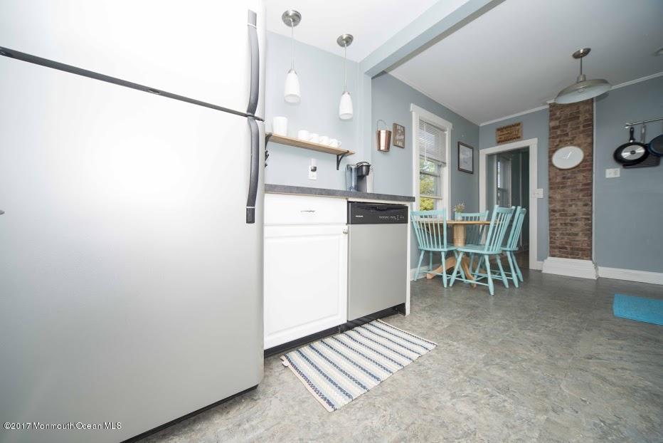 402 Maple Drive Belford, NJ 07718 - Photo 11 of 18 a view of kitchen with refrigerator and table