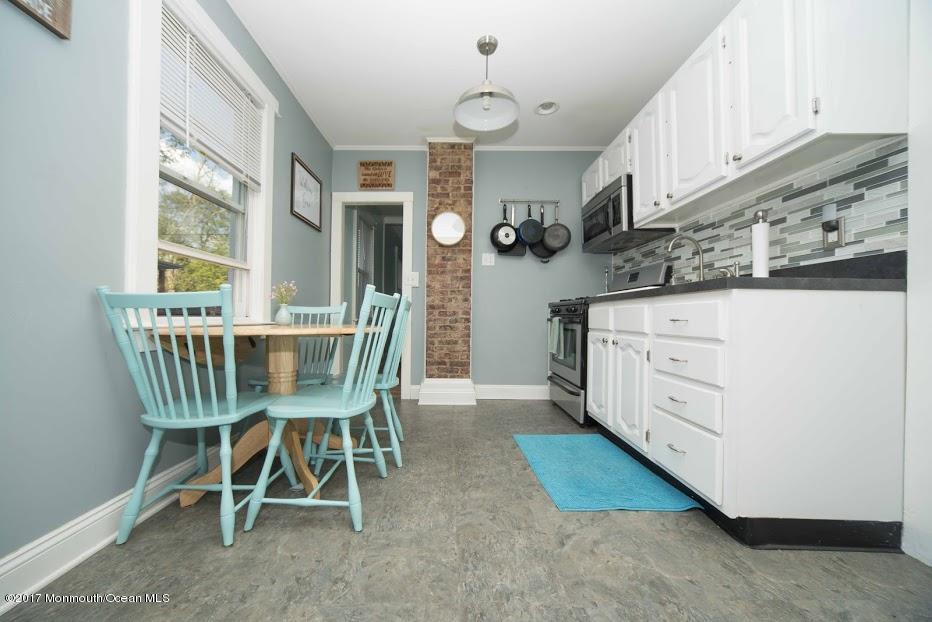 402 Maple Drive Belford, NJ 07718 - Photo 13 of 18 a view of a kitchen with a table and chairs
