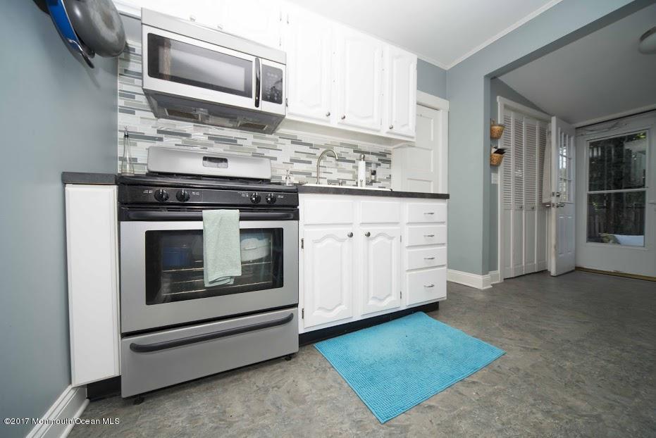 402 Maple Drive Belford, NJ 07718 - Photo 14 of 18 a kitchen with granite countertop stainless steel appliances and cabinets