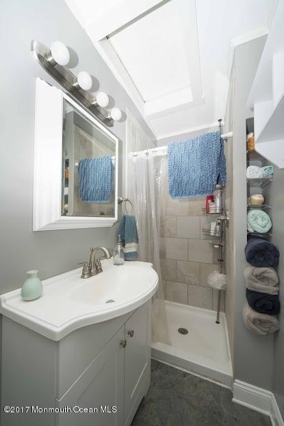 402 Maple Drive Belford, NJ 07718 - Photo 15 of 18 a bathroom with a sink a shower and a mirror