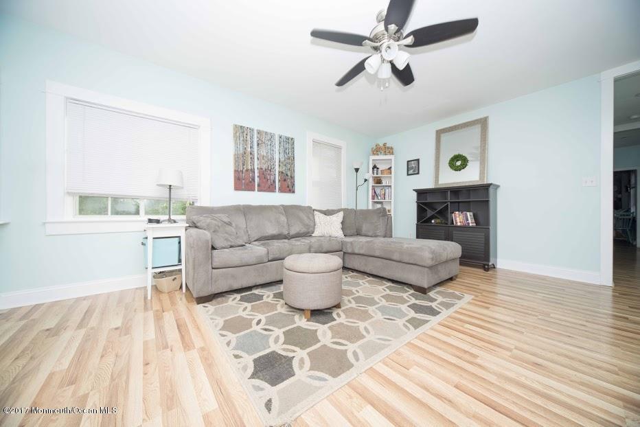 402 Maple Drive Belford, NJ 07718 - Photo 2 of 18 a living room with furniture and a fireplace