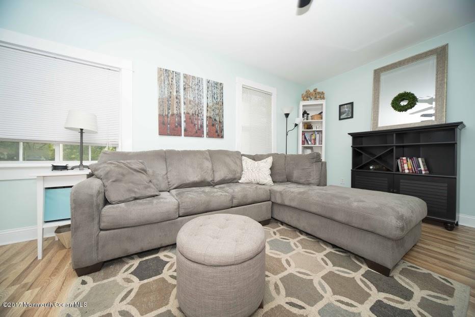 402 Maple Drive Belford, NJ 07718 - Photo 3 of 18 a living room with furniture and a fireplace