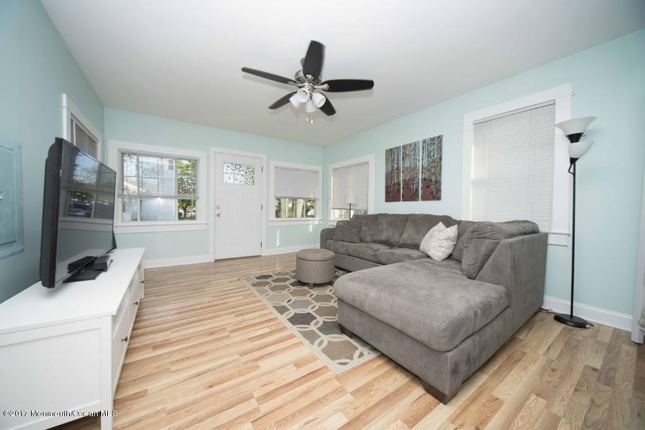 402 Maple Drive Belford, NJ 07718 - Photo 4 of 18 a living room with couches and furniture with wooden floor