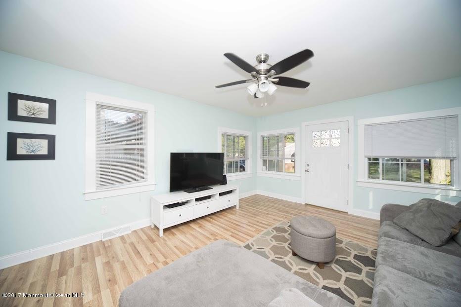 402 Maple Drive Belford, NJ 07718 - Photo 5 of 18 a living room with furniture and a flat screen tv