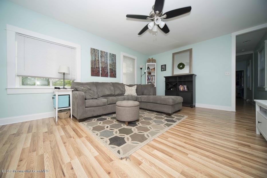 402 Maple Drive Belford, NJ 07718 - Photo 6 of 18 a living room with furniture and a fireplace