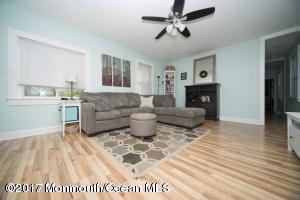 402 Maple Drive Belford, NJ 07718 - Photo 7 of 18 a living room with furniture and a fireplace