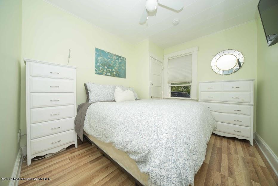 402 Maple Drive Belford, NJ 07718 - Photo 8 of 18 a bedroom with a bed and cabinet