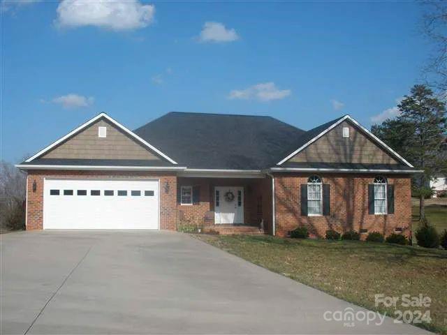 231 Hunters Trace Rutherfordton, NC 28139 - Photo 1 of 1 a front view of a house with a yard and garage