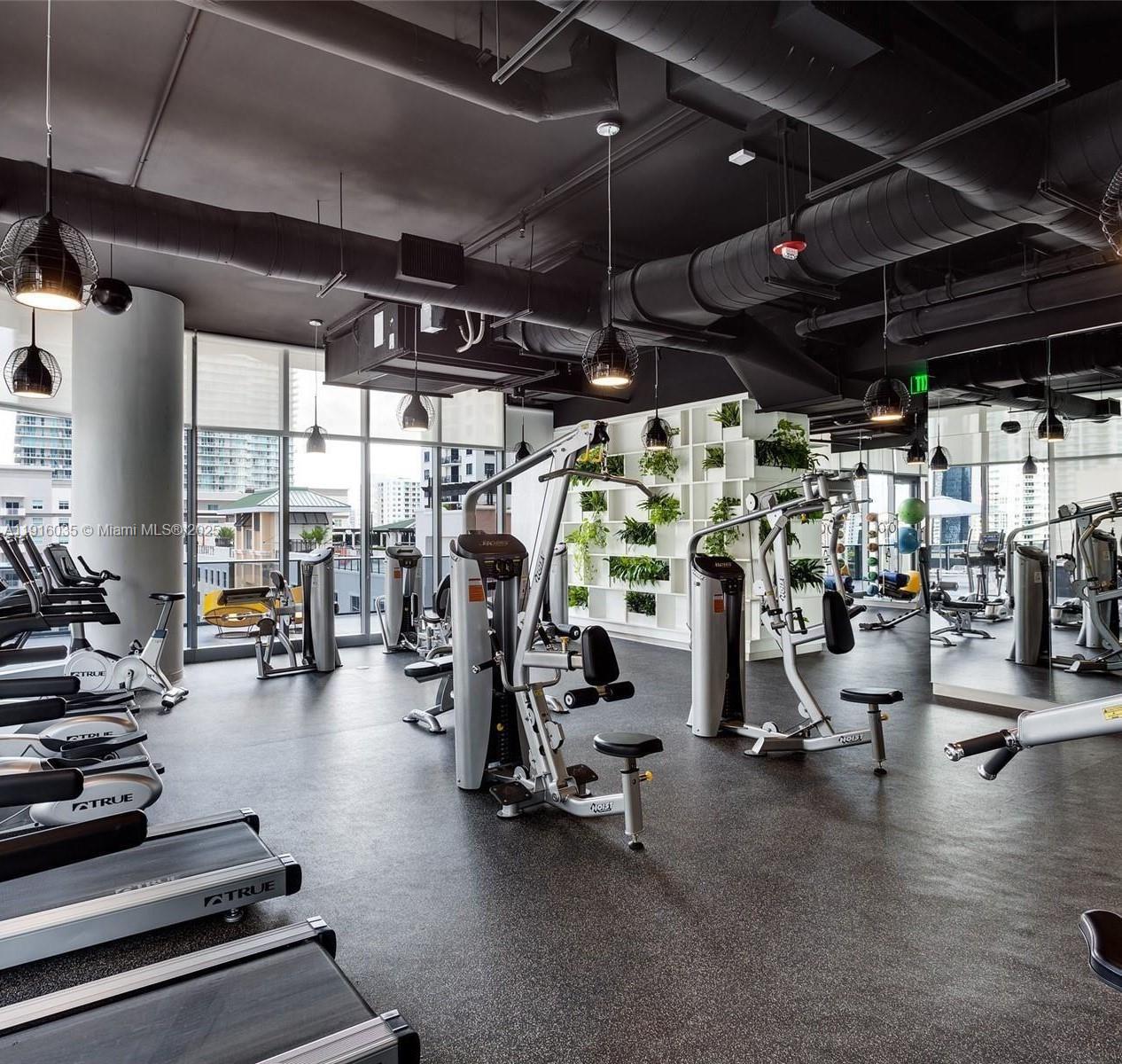 55 Southwest 9th Street, Unit 2902 Miami, FL 33130 - Photo 12 of 22 a view of a room with gym equipment