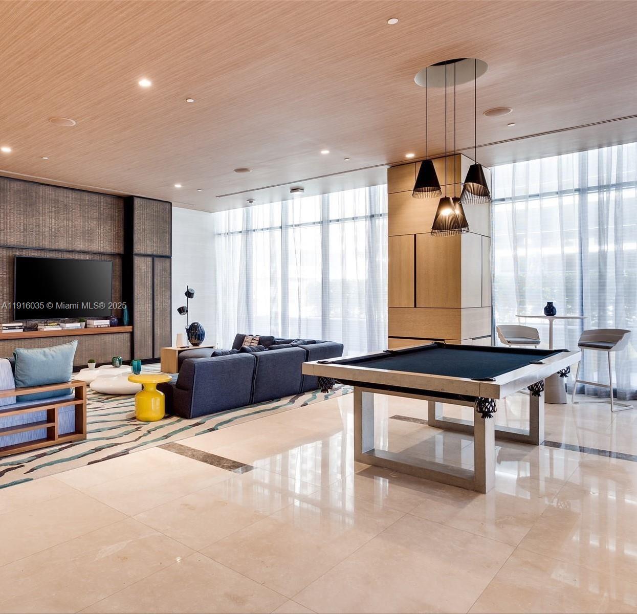 55 Southwest 9th Street, Unit 2902 Miami, FL 33130 - Photo 16 of 22 a living room with furniture a flat screen tv and a large window