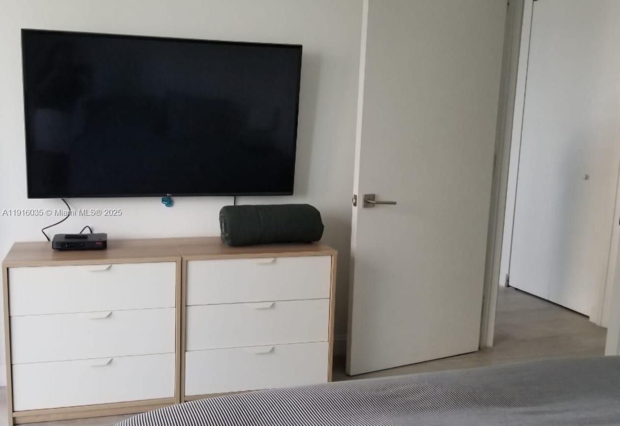 55 Southwest 9th Street, Unit 2902 Miami, FL 33130 - Photo 18 of 22 a bathroom with a sink and a mirror