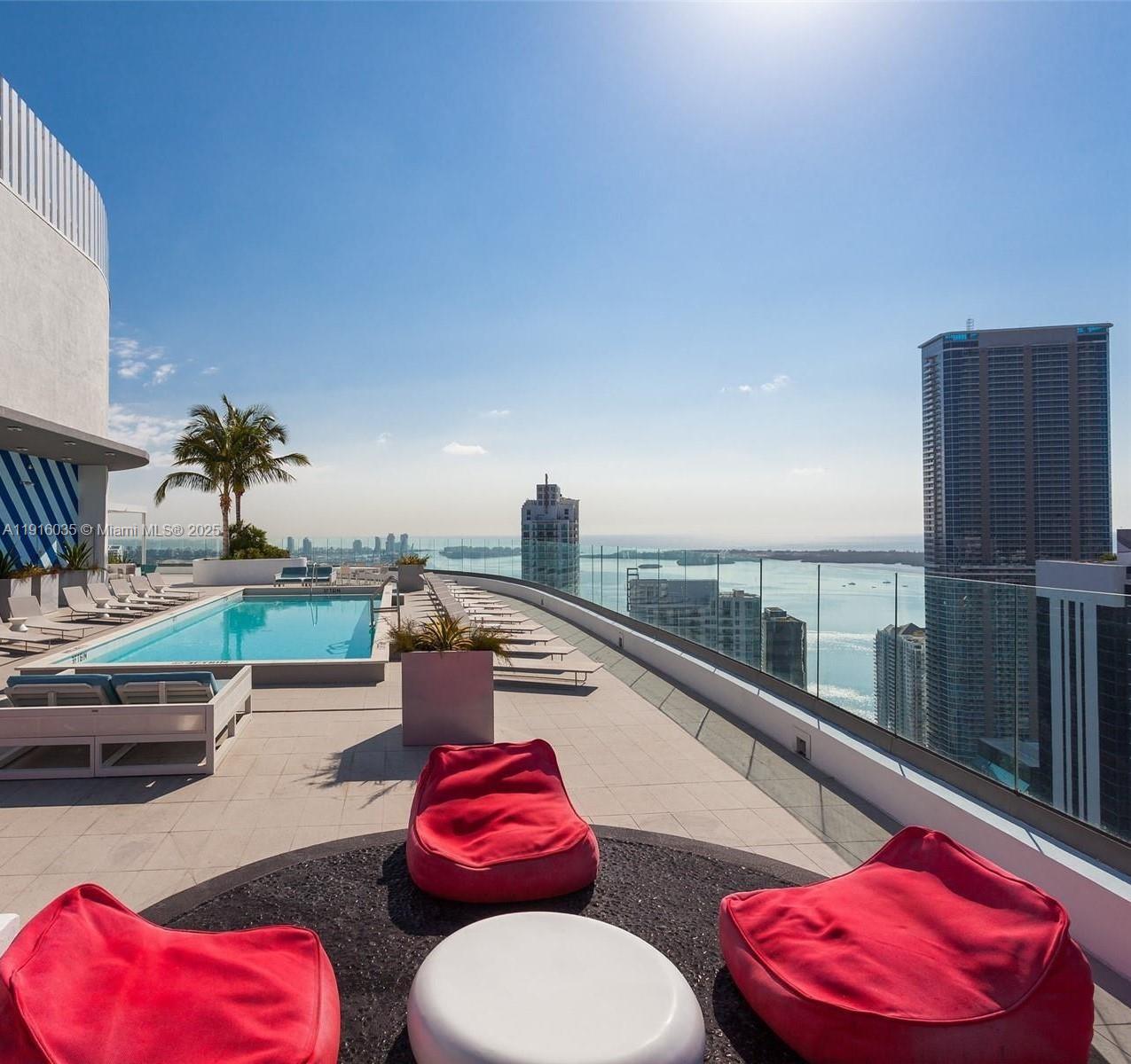 55 Southwest 9th Street, Unit 2902 Miami, FL 33130 - Photo 2 of 22 a view of a balcony with chair and potted plants