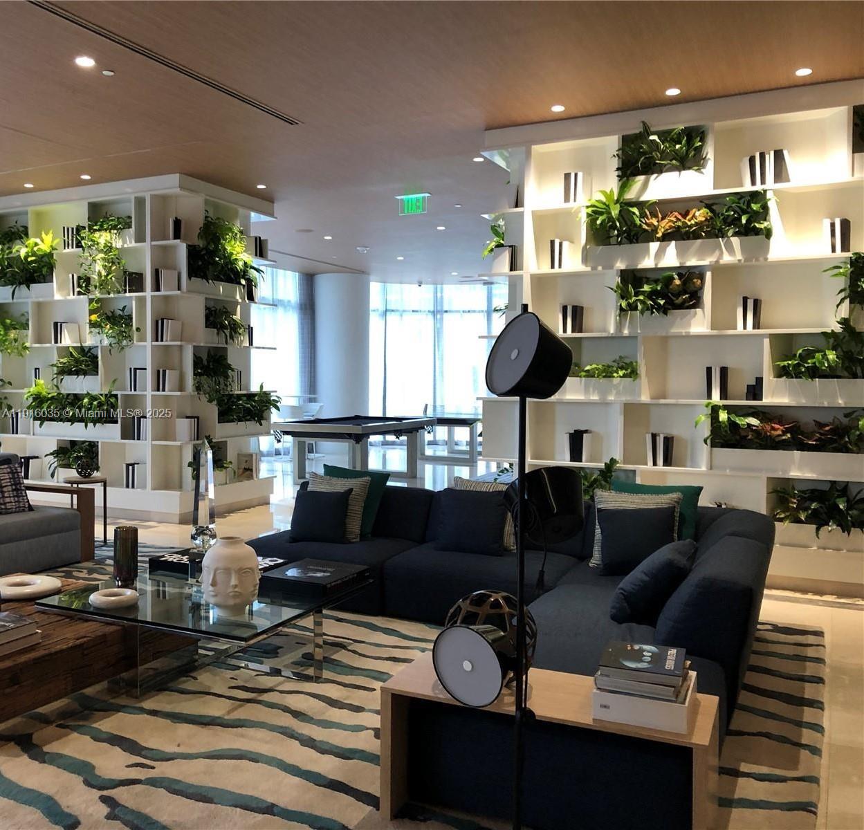 55 Southwest 9th Street, Unit 2902 Miami, FL 33130 - Photo 9 of 22 a living room with lots of furniture and kitchen view