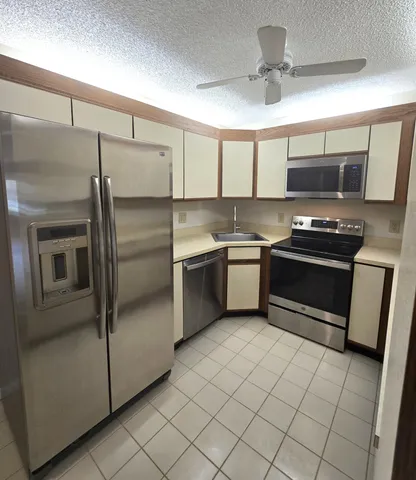 a bathroom with a granite countertop sink toilet mirror and shower