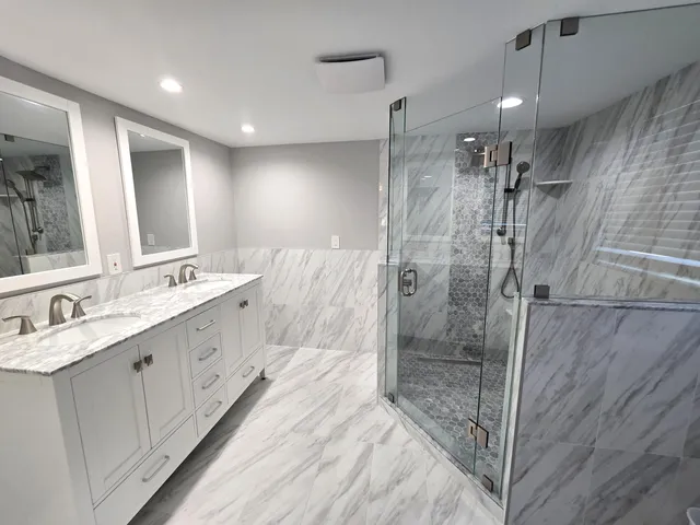 a large bathroom with a double vanity sink a mirror and shower