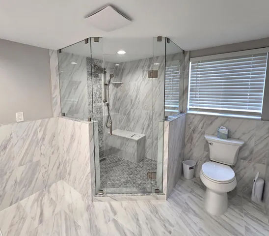 a bathroom with a toilet shower and a sink