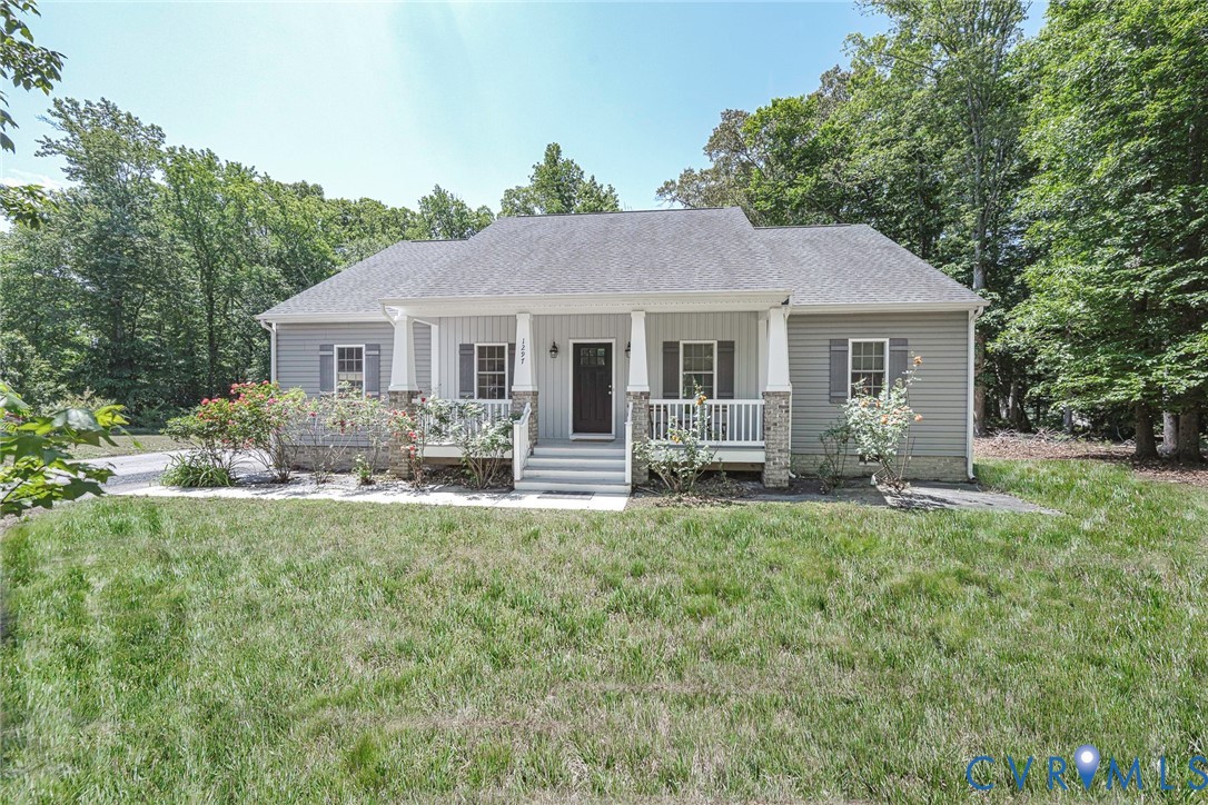 1297 Manfield Road Aylett, VA 23009 - Photo 1 of 41 a view of a house with a yard and potted plants