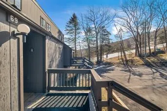 a view of a wooden house with a bench