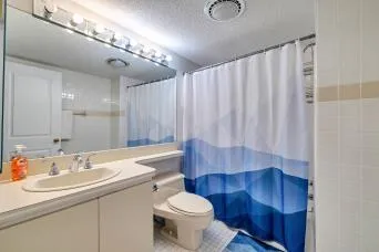 a bedroom with a bed and a night stand