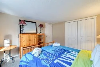 a bedroom with a bed and a painting on the wall