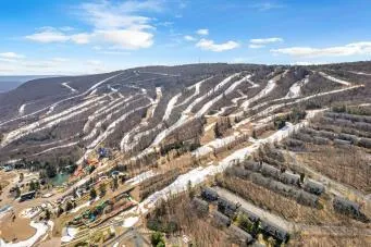 a view of a wooden house with a bench