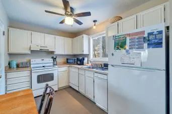 a room with stainless steel appliances kitchen island granite countertop furniture and a dining table