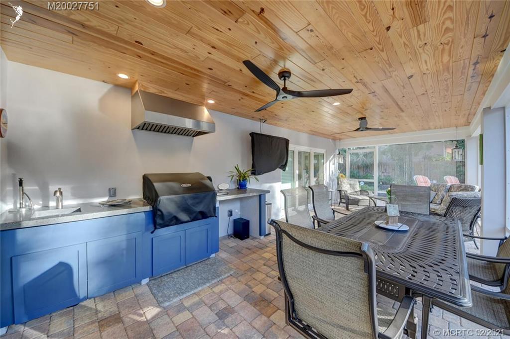 814 Southeast Riverside Drive Stuart, FL 34994 - Photo 26 of 48 Large screened in back porch with outdoor kitchen and tongue & groove insulated ceiling.