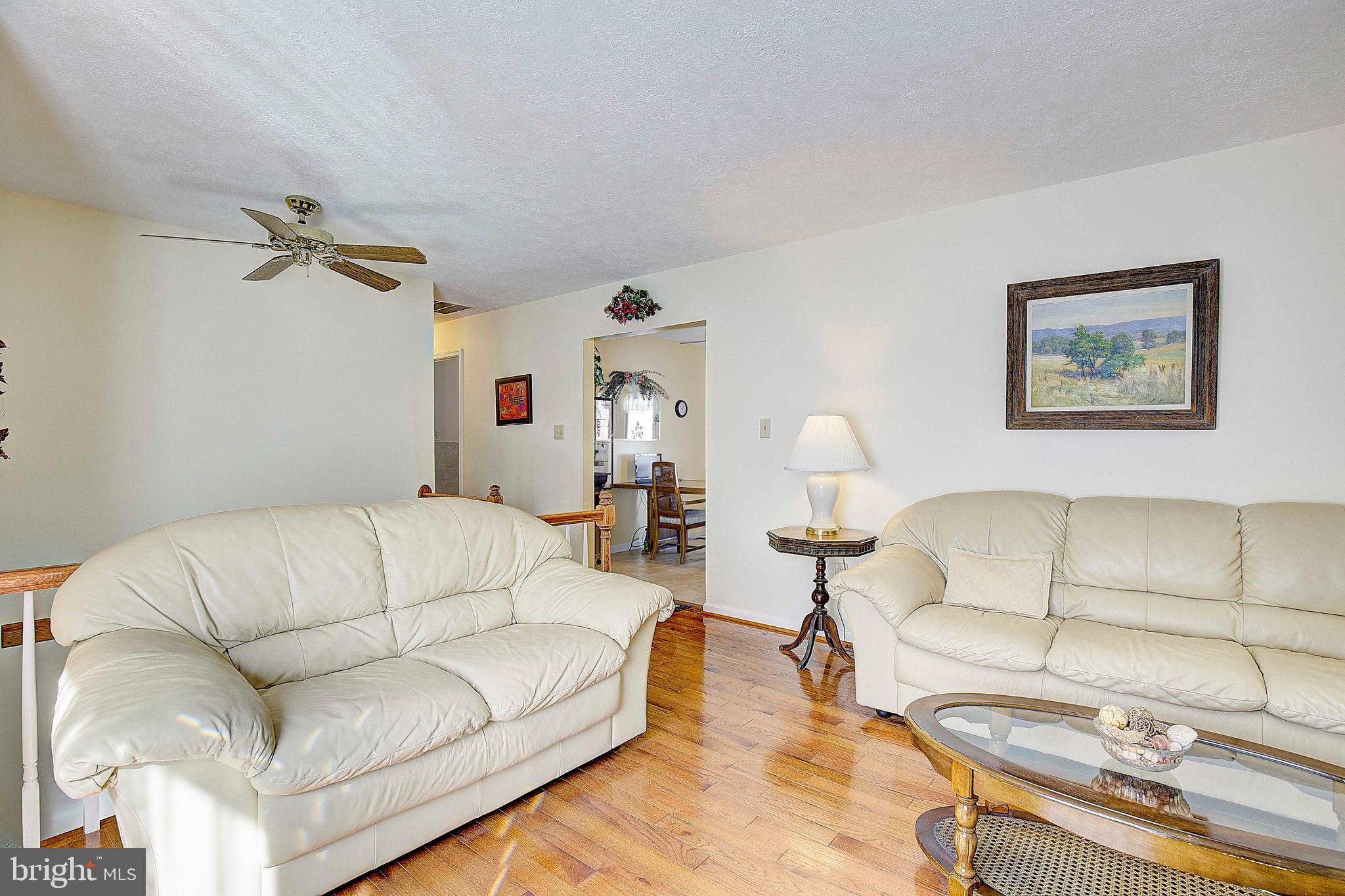 5018 Long Beach Road St. Leonard, MD 20685 - Photo 13 of 39 a living room with furniture a couch and a chandelier