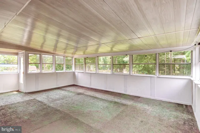 an empty room with large windows