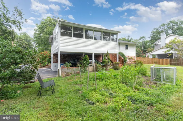 a view of a house with a yard and sitting area