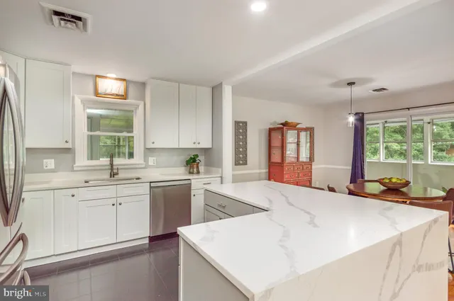 a large white kitchen with a window