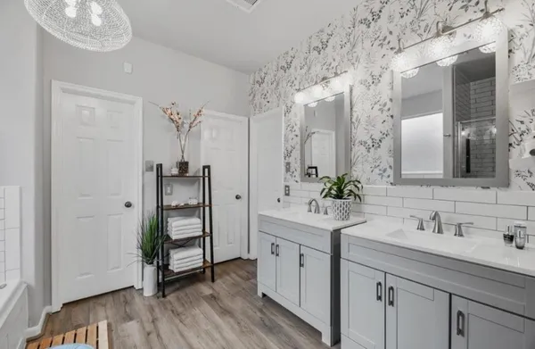 a bathroom with a double vanity sink and mirror